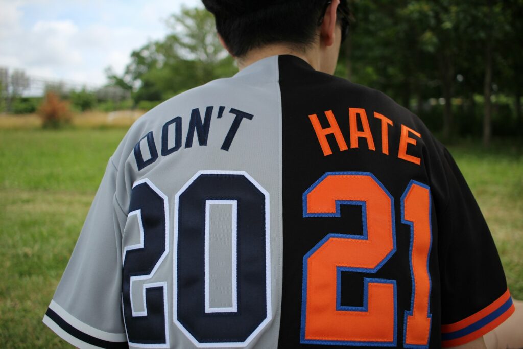 a baseball player wearing a jersey that says don't hate