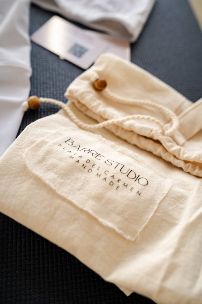 A close-up shot of handmade apparel packaging with the logo 'Bayre Studio' and branding details.