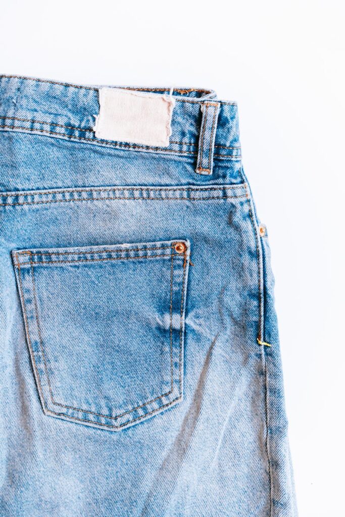 Close-up of the back pocket and tag on a pair of blue denim jeans.