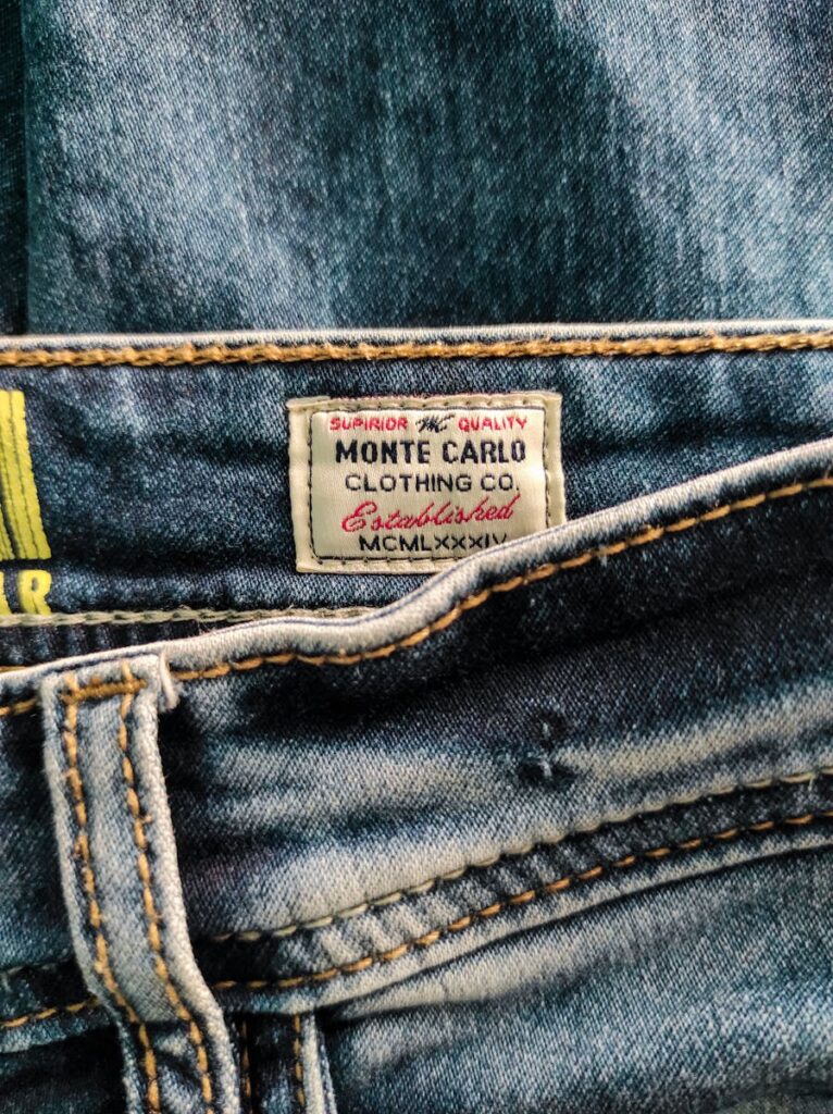 Detailed view of Monte Carlo Clothing Co. label on denim fabric.