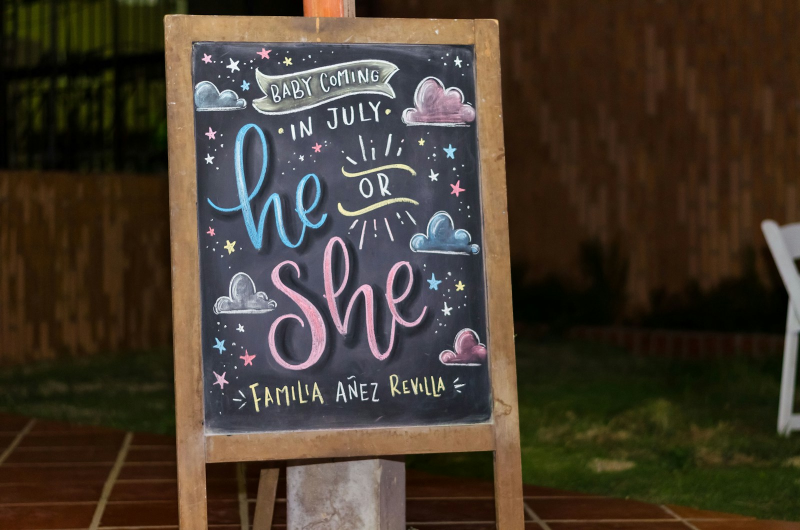 brown framed chalkboard easel with baby coming in July he or she text gender reveal shirts