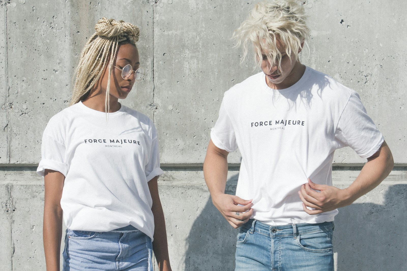 man and woman in white-and-gray force majeure-printed crew-neck t-shirts standing near gray concrete wall how to make dtf transfers