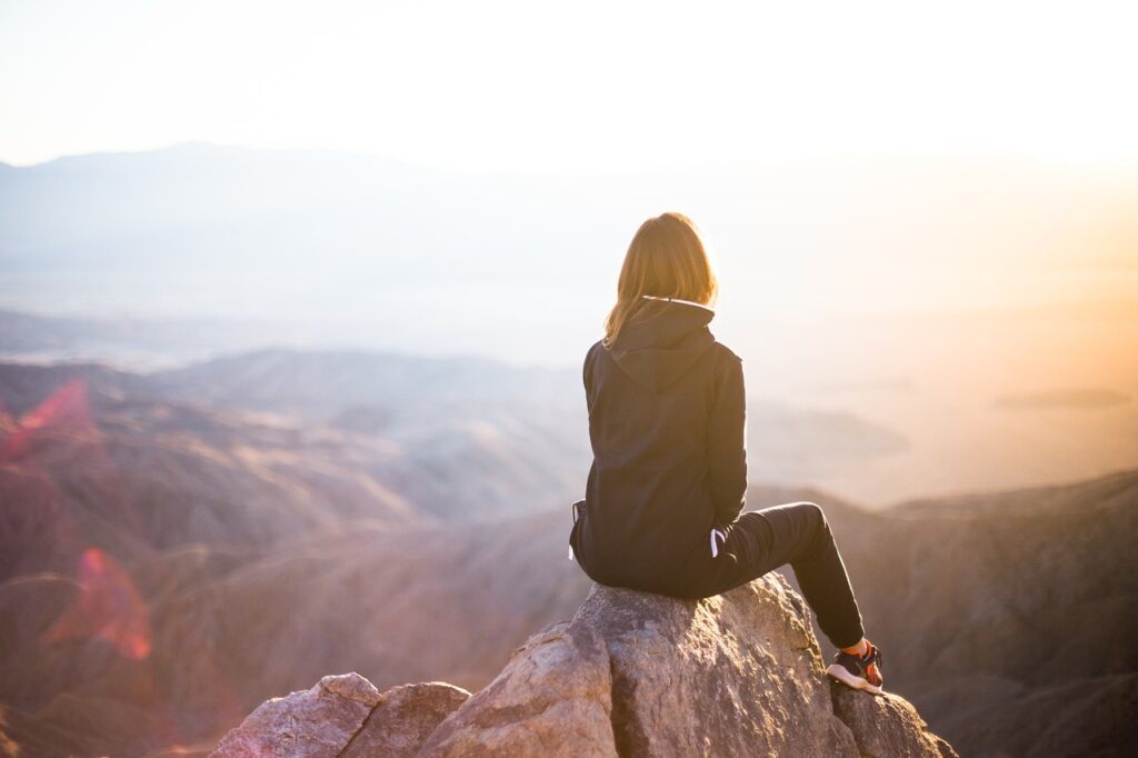 people, woman, travel, adventure, trek, mountain, rock, nature, sunset, cliff, black, hoodie, jacket, alone, thinking, freedom