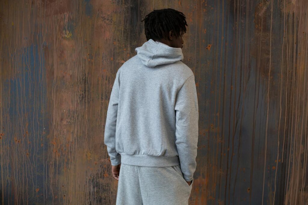 Back view of African American male wearing casual clothes in sportive style standing with hand in pocket