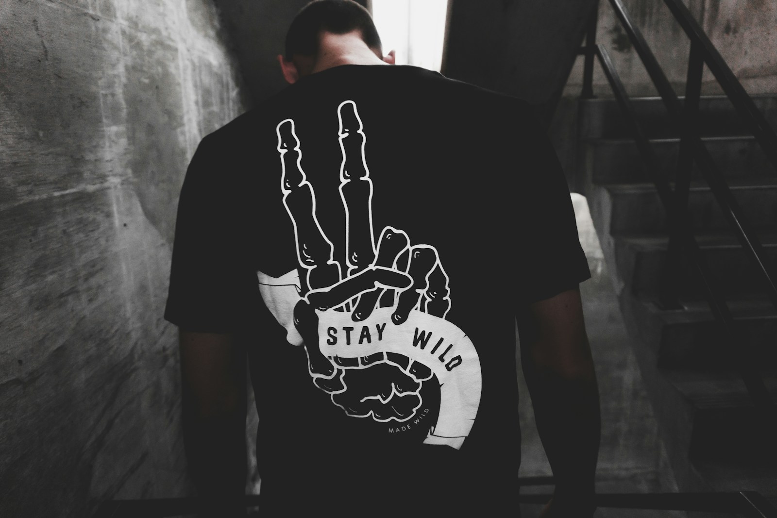 person wearing white and black shirt standing near wall custom dtf transfers