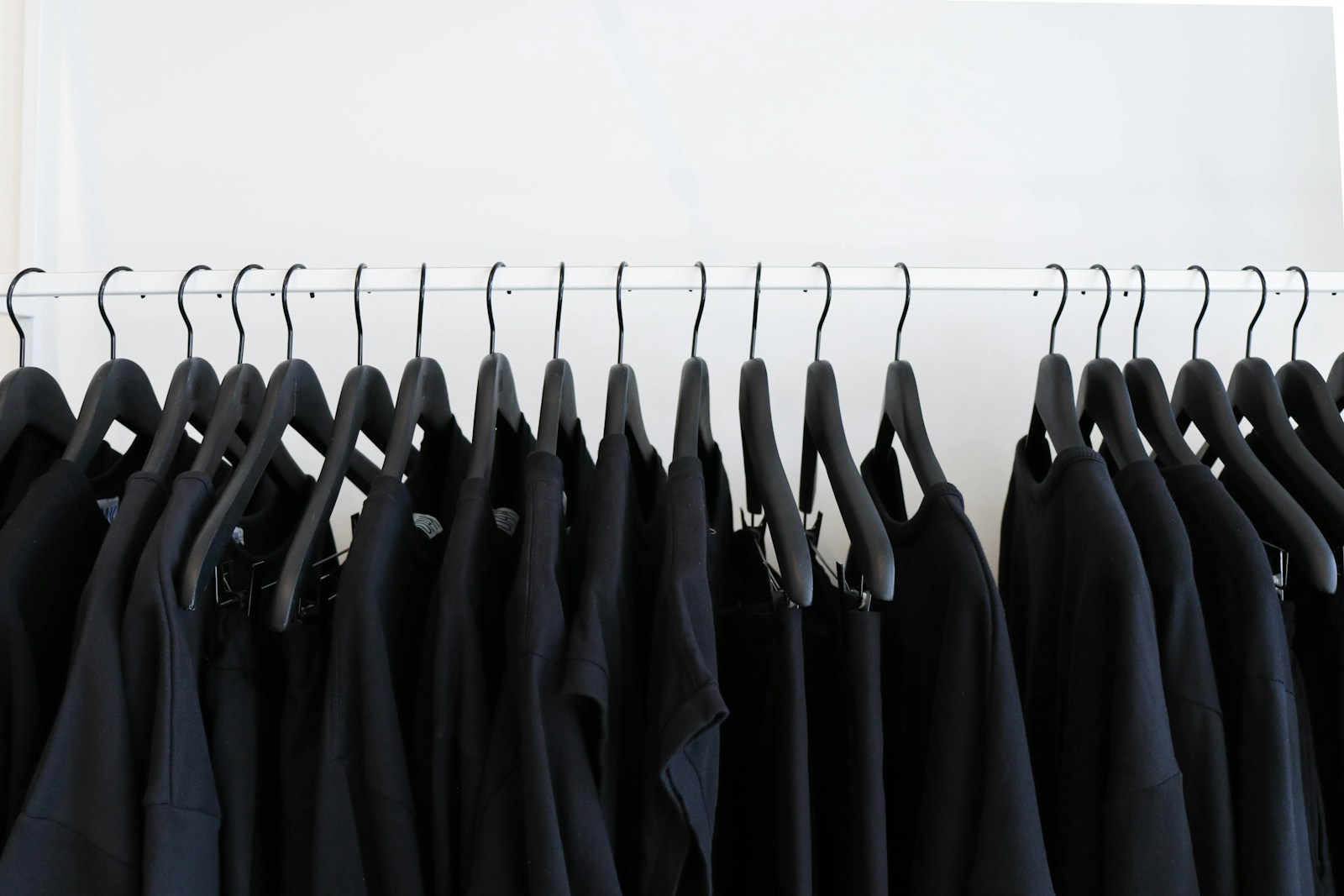 black clothes hanged in rack tri blend t shirts