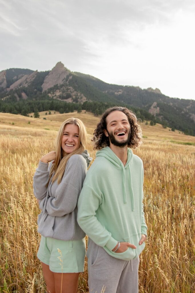 a man and a woman standing in a field