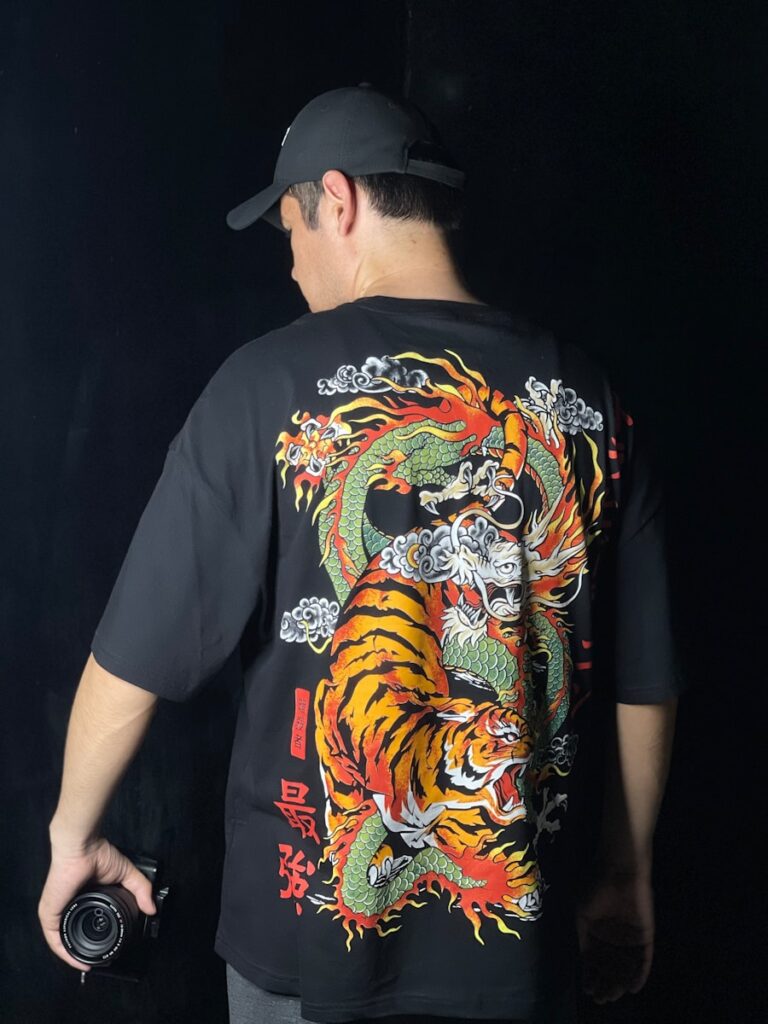 a man wearing a black shirt with a tiger on it