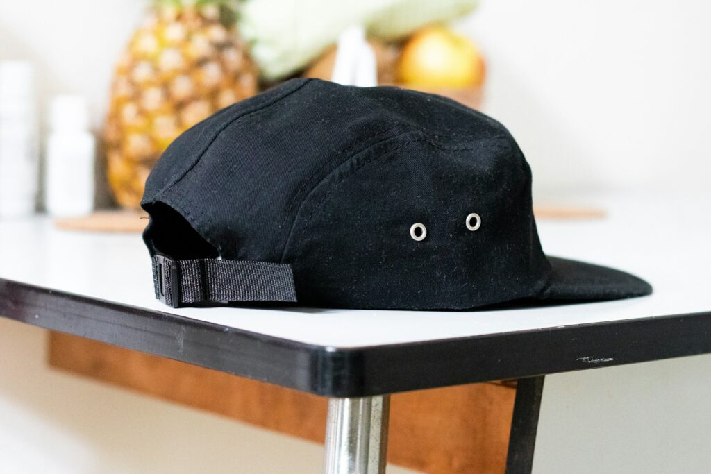 black and white cap on white table