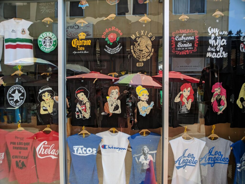 a store front window with t - shirts and umbrellas (DTF Gang Sheets) | Save Money & Maximize Printing Efficiency