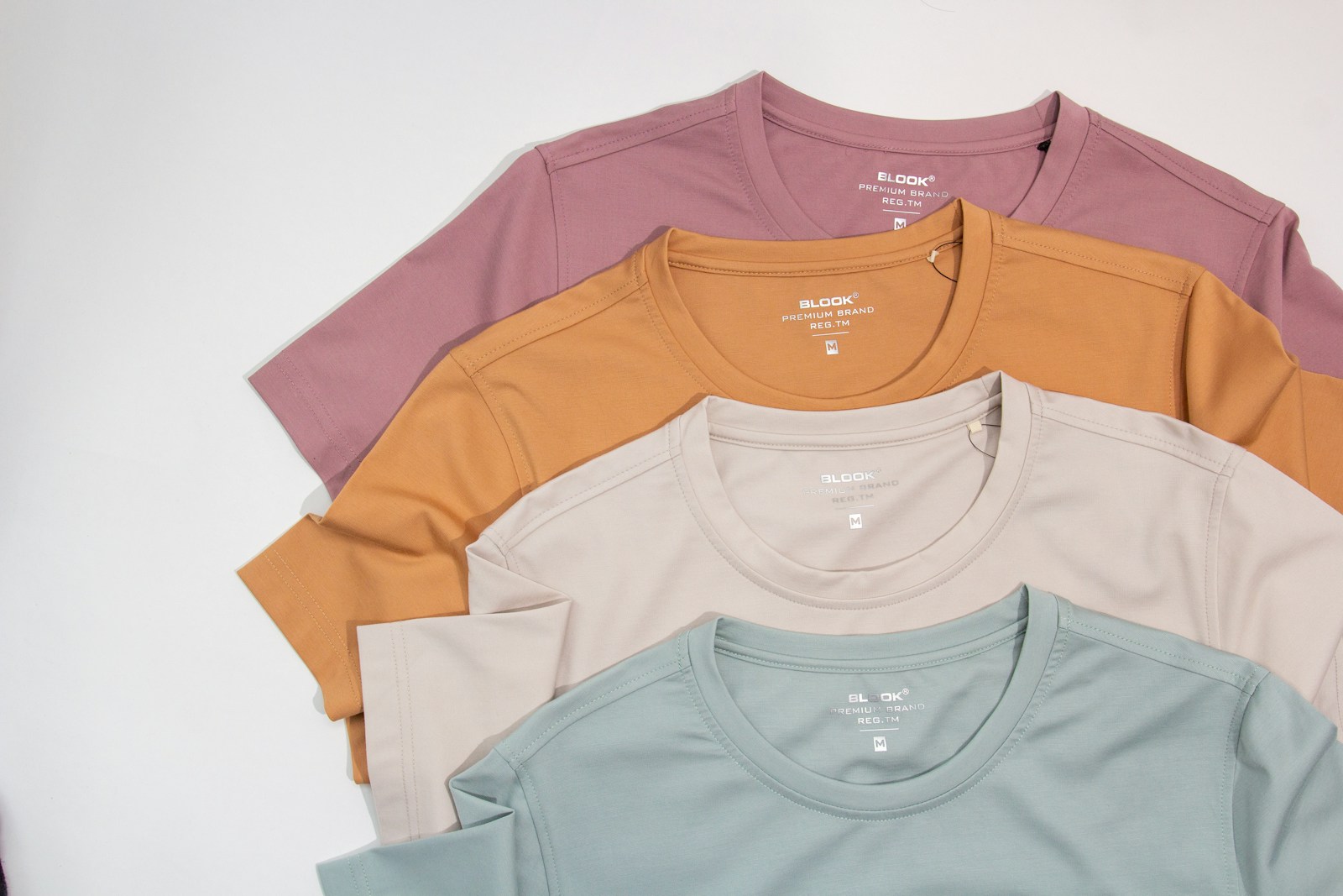 a group of five t - shirts sitting on top of each other (DTF Transfers) | Everything You Need to Know About Printing Success