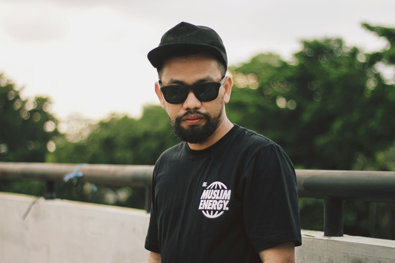 Photo by kawah kaos dakwah a man wearing a black hat and sunglasses (Direct to Film) | The Printing Technology Changing Apparel