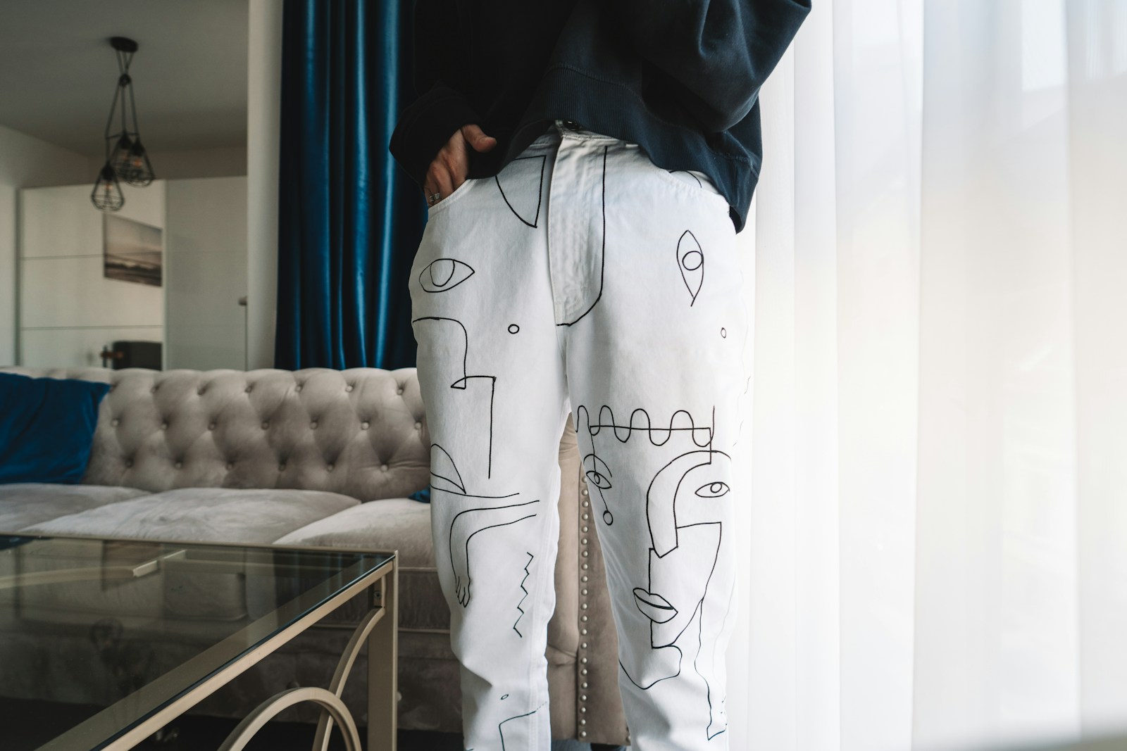 person in black and white pajama set standing near white sofa (Custom DTF Transfers) | Create Unique Apparel for Your Brand