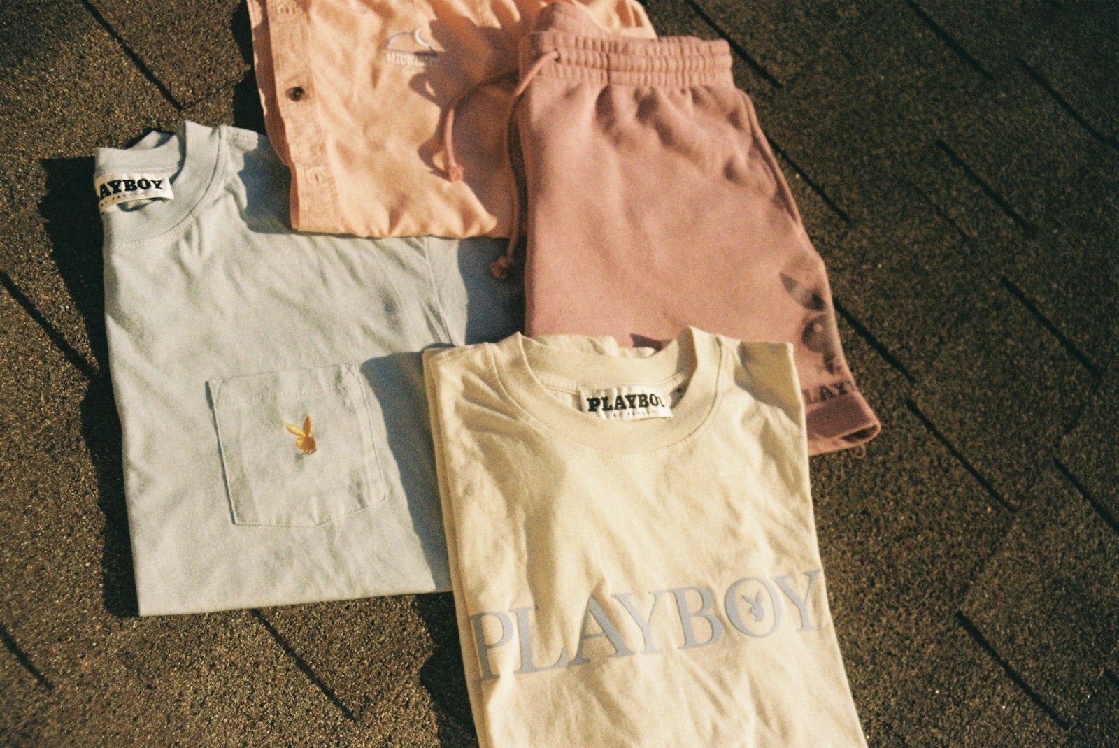 a group of four t - shirts sitting on top of a sidewalk Selling Custom (Shirts) with DTF Transfers | The Ultimate Social Media Tips & Tricks