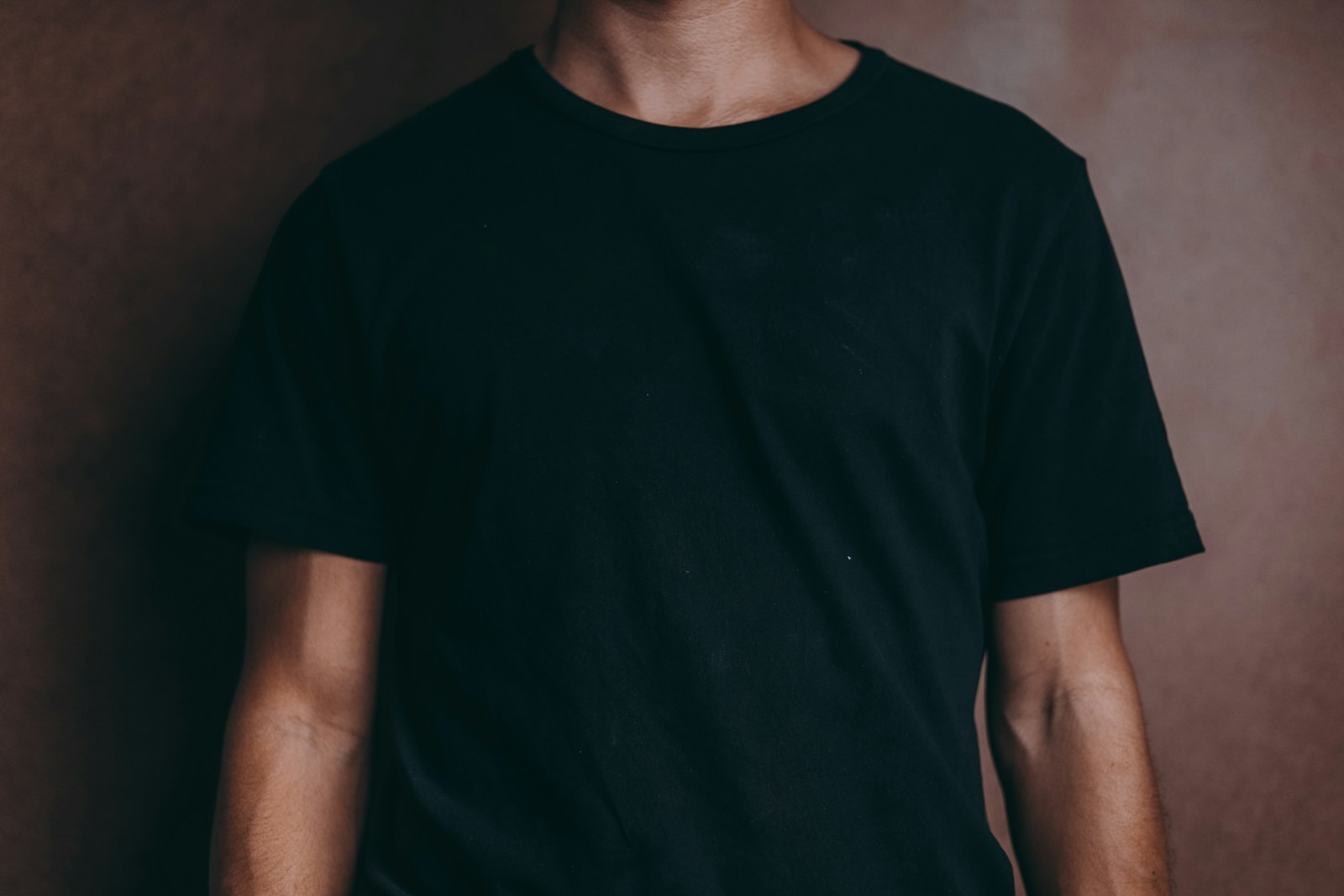 man wearing black crew-neck t-shirt (DTF Transfers) on Dark Garments and Tricky Fabrics: What You Need to Know