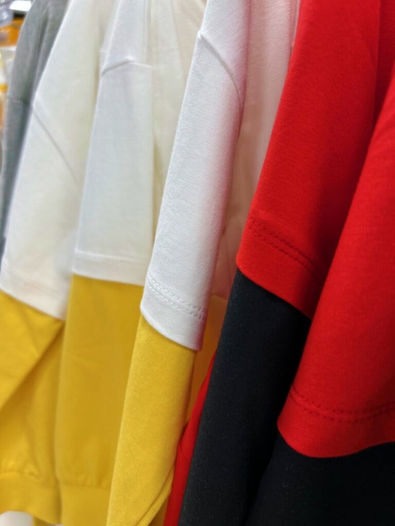 Close-up of colorful t-shirts on display showcasing soft cotton fabric and casual style.