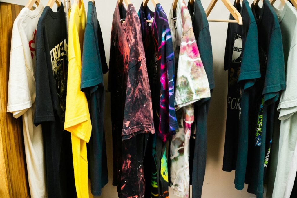 Assortment of t-shirts hanging on a rack.