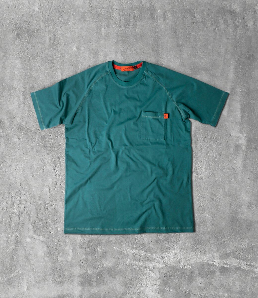 Photo by Hamed darzi a green t - shirt sitting on a concrete floor