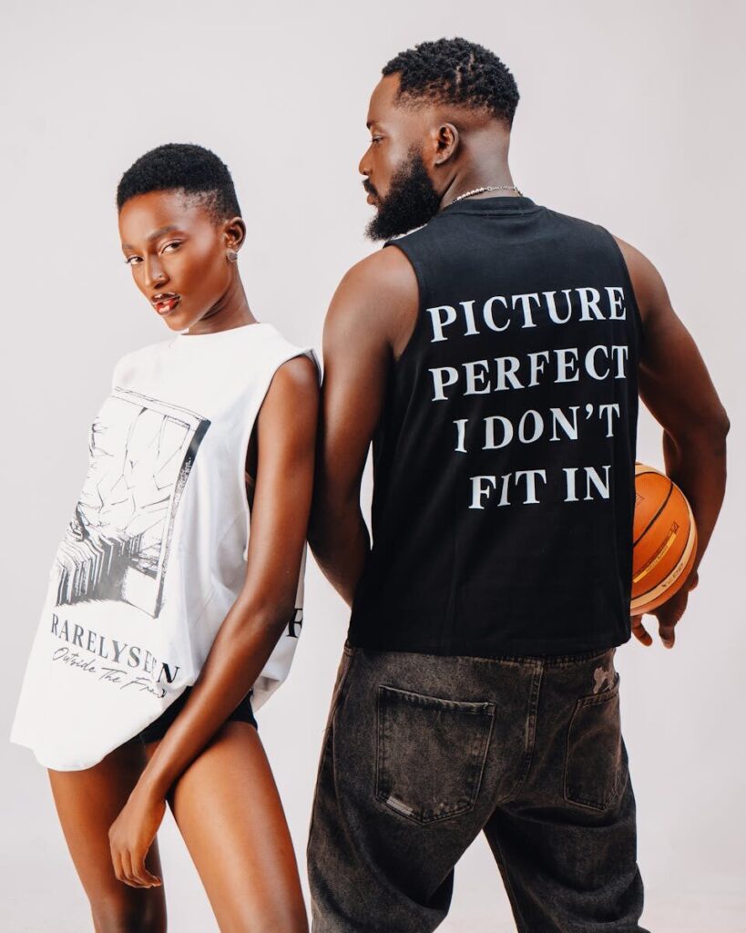 Two stylish adults pose confidently showcasing bold streetwear fashion.