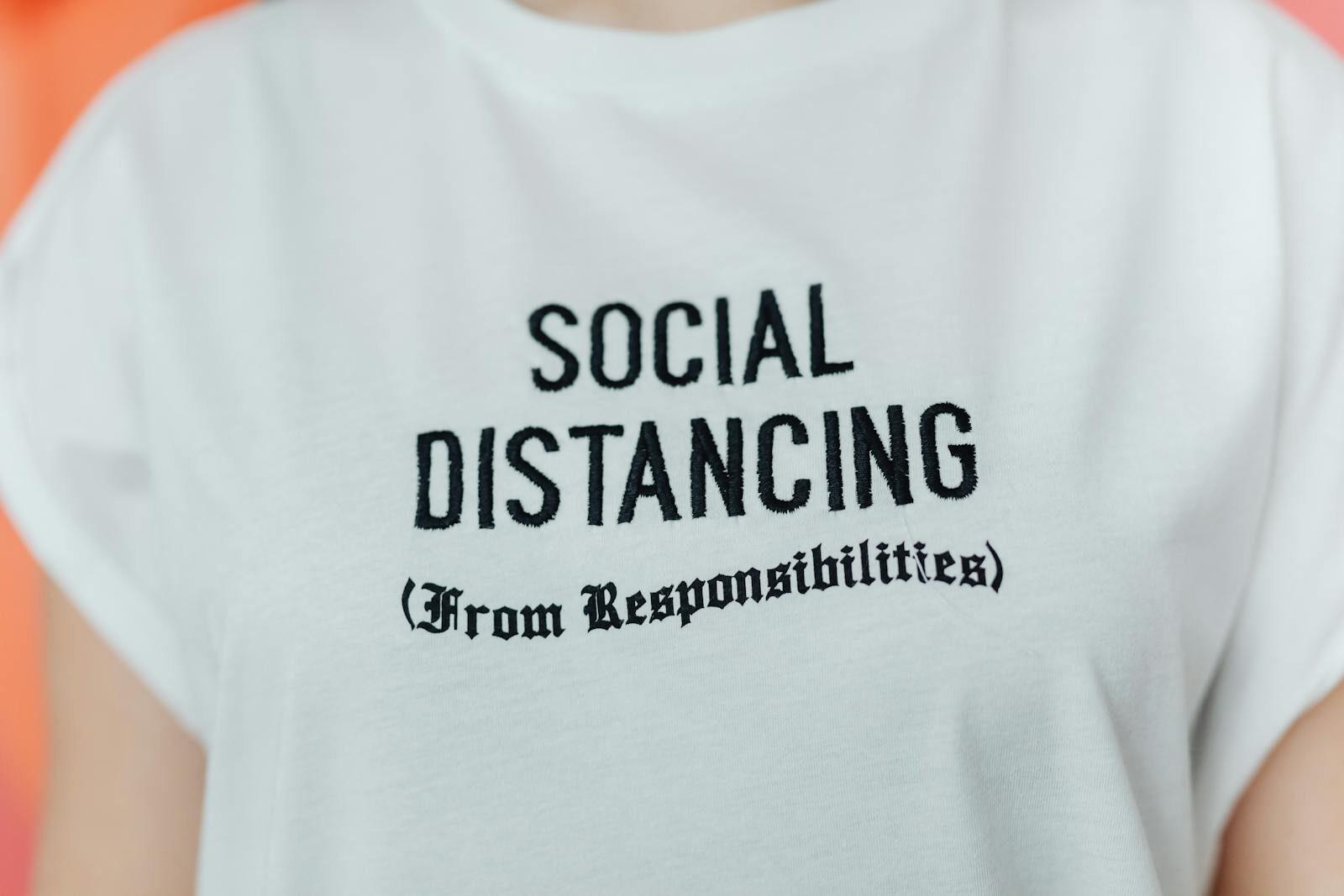 Close-up of a white T-shirt with 'Social Distancing' embroidered in black text. DTF Transfer Mistakes to Avoid for Better Print Results