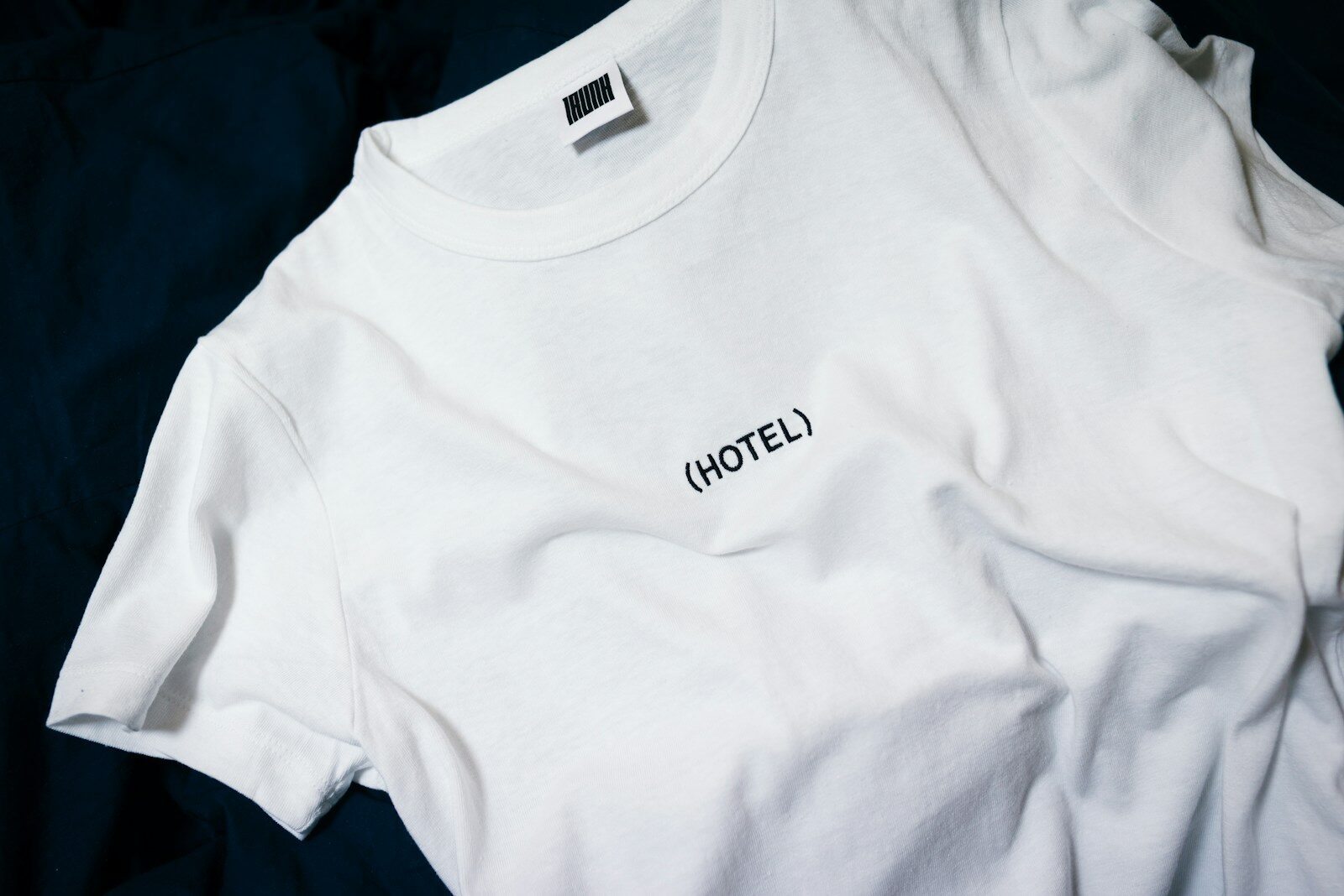 white hotel-printed crew-neck shirt on black surface Custom DTF Transfers: How to Order Like a Pro (Without Wasting Money)