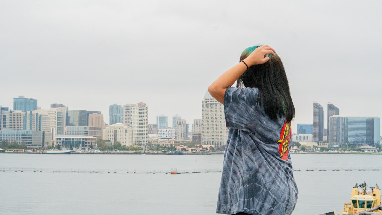 Woman views a city skyline on a cloudy day. DTF Transfer Tips for Beginners: How to Get Started the Right Way