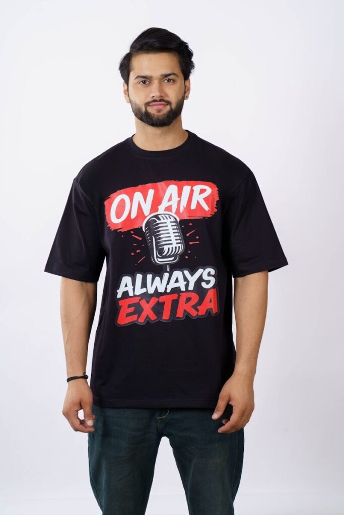 Man in black t-shirt with "on air always extra" graphic
