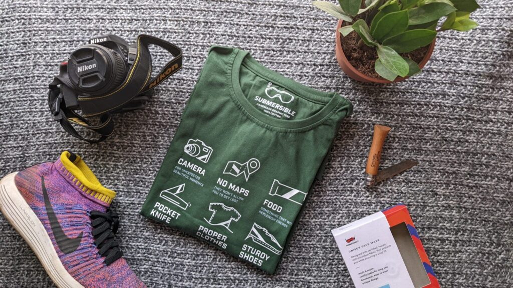 a green bag with a black bag and a pair of shoes DTF Transfers vs Screen Printing: Which Is Better?