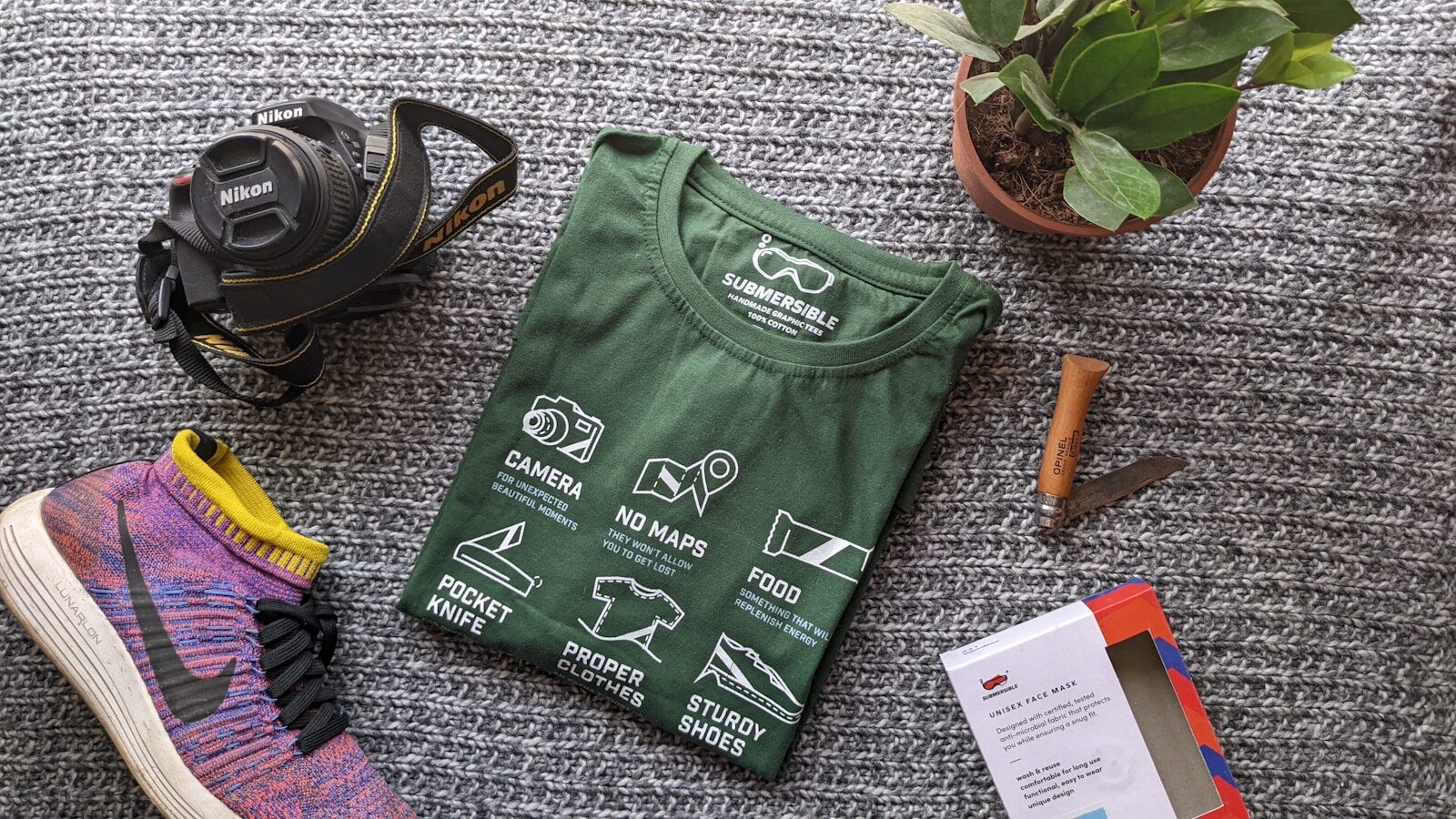 a green bag with a black bag and a pair of shoes DTF Transfers vs Screen Printing: Which Is Better?