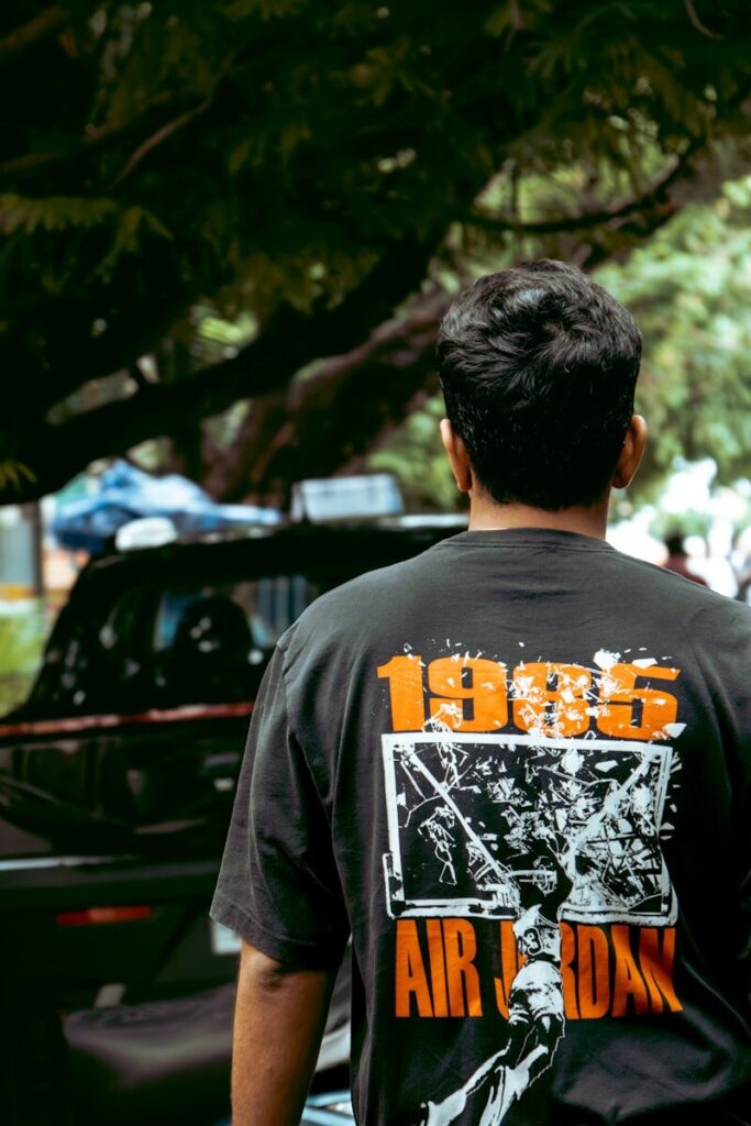 Man wearing a black t-shirt with "1995 air jordan" graphic.