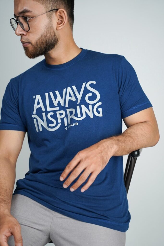 man in blue crew neck t-shirt sitting on black chair