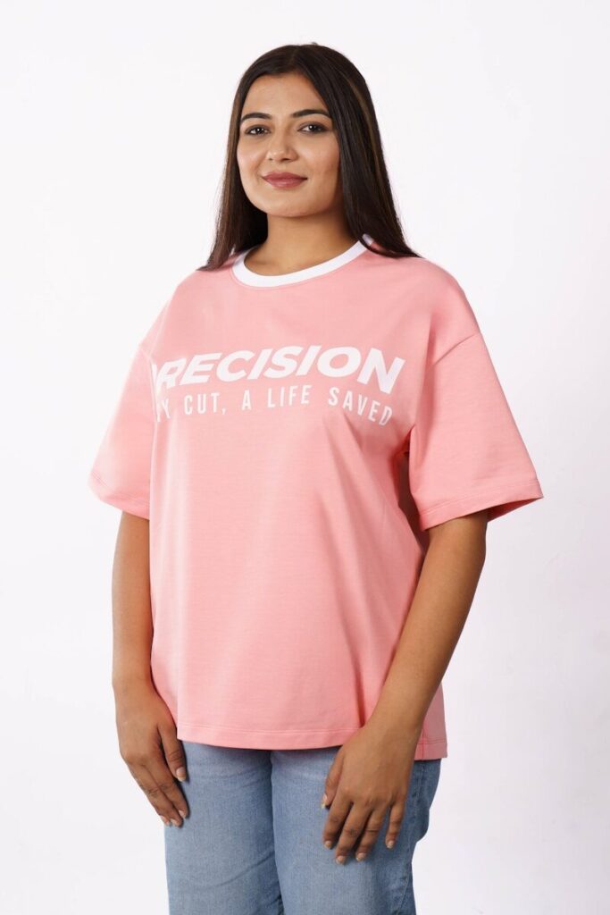 A woman wearing a pink t-shirt with text