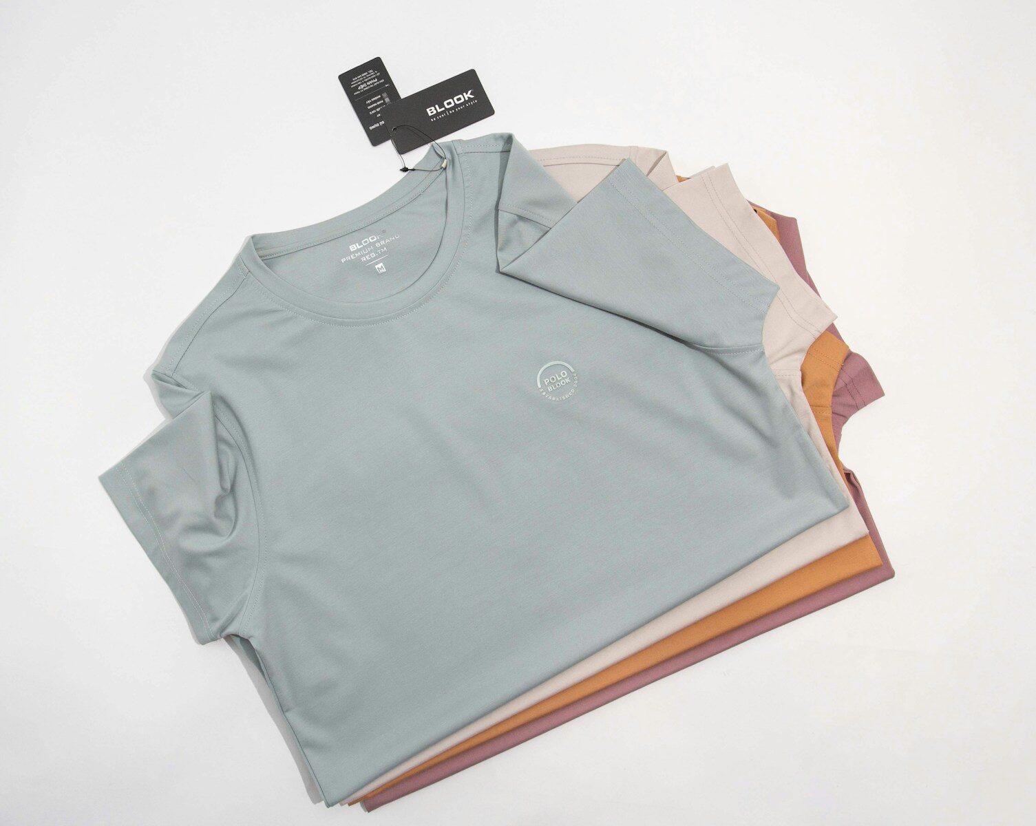 a pile of t - shirts sitting on top of each other 10 Benefits of DTF Transfers That Make Them a Game-Changer